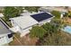 Home with solar panels, mature trees, and a privacy-fenced backyard at 2066 High Ridge Dr, Clearwater, FL 33763