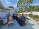 Patio with several outdoor grills and seating area in the backyard at 2066 High Ridge Dr, Clearwater, FL 33763
