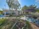 Lawn and patio with lawn mower, grill, and seating in the backyard at 2066 High Ridge Dr, Clearwater, FL 33763
