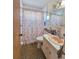 A full bathroom with seashell-themed decor, toilet and tile flooring at 2066 High Ridge Dr, Clearwater, FL 33763
