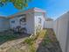 Charming home exterior with a white fence, awning-covered window, and a neat, well-maintained side yard space at 2066 High Ridge Dr, Clearwater, FL 33763