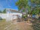 Side yard showcasing the home's exterior, landscaping and charming details of the residence at 2066 High Ridge Dr, Clearwater, FL 33763