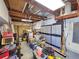 View of a cluttered garage with shelves and tools along the walls at 2066 High Ridge Dr, Clearwater, FL 33763