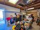 View of a cluttered garage with tools and storage containers at 2066 High Ridge Dr, Clearwater, FL 33763