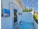 Home exterior featuring a side entrance, access to electrical panels, and well-maintained surroundings at 2066 High Ridge Dr, Clearwater, FL 33763