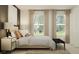 Bedroom features modern decor, warm lighting, and large windows at 2284 Blue Grosbeak Pl, Wimauma, FL 33598
