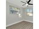 Bright bedroom with a ceiling fan and two windows providing natural light at 243 45Th N St, St Petersburg, FL 33713