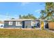 Charming single-story home with a well-maintained lawn and a bright yellow front door at 243 45Th N St, St Petersburg, FL 33713