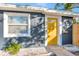 Close-up of the home's bright yellow front door and freshly painted exterior at 243 45Th N St, St Petersburg, FL 33713