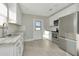 Bright kitchen featuring stainless steel appliances, white cabinets, and ample counter space at 243 45Th N St, St Petersburg, FL 33713