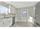Updated kitchen with white cabinets, stainless steel appliances and stylish backsplash at 243 45Th N St, St Petersburg, FL 33713