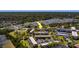 Expansive aerial view of a condo community, showcasing well-maintained buildings, green spaces, and nearby amenities at 2700 Bayshore Blvd # 588, Dunedin, FL 34698