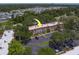 Aerial view of the complex surrounded by mature trees and a parking area at 2700 Bayshore Blvd # 588, Dunedin, FL 34698