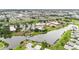 Aerial view of a community clubhouse, pool, lake, and surrounding community at 301 Andover S Pl # 175, Sun City Center, FL 33573