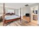 Bedroom features wood floors and four poster bed with an attached bathroom at 301 Andover S Pl # 175, Sun City Center, FL 33573