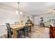 Charming dining area with wood floors and view of living room, offering open living at 301 Andover S Pl # 175, Sun City Center, FL 33573