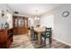 Bright dining area with wood floors, traditional furniture, and a view into the bedroom at 301 Andover S Pl # 175, Sun City Center, FL 33573