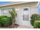Close-up of the front door, showcasing the well-lit entry and neat landscaping at 301 Andover S Pl # 175, Sun City Center, FL 33573