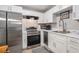 Clean kitchen features stainless steel appliances, white cabinets, and modern fixtures at 301 Andover S Pl # 175, Sun City Center, FL 33573