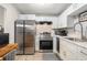 Bright kitchen with stainless steel appliances, ample counter space, and white cabinets at 301 Andover S Pl # 175, Sun City Center, FL 33573