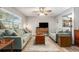 Cozy living room featuring neutral decor, wood floors, and ample natural light at 301 Andover S Pl # 175, Sun City Center, FL 33573