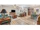 Open-concept living area with wood floors, stylish furnishings, and seamless flow at 301 Andover S Pl # 175, Sun City Center, FL 33573