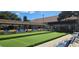 Outdoor bocce ball court with shaded seating areas and well maintained artificial grass at 3509 Oak Lake Dr, Palm Harbor, FL 34684
