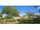 Entrance to the Highland Lakes Club with lush green landscaping and an American flag at 3509 Oak Lake Dr, Palm Harbor, FL 34684