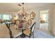 Inviting dining area with chandelier, and comfortable seating, open to the living room at 3509 Oak Lake Dr, Palm Harbor, FL 34684