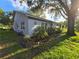 Well-maintained home exterior with green lawn and manicured landscaping at 3509 Oak Lake Dr, Palm Harbor, FL 34684
