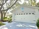Exterior view of the home's garage with a white door at 3509 Oak Lake Dr, Palm Harbor, FL 34684