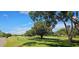 Beautiful golf course view with lush green grass, mature trees and blue skies in this picturesque community at 3509 Oak Lake Dr, Palm Harbor, FL 34684