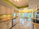 Modern kitchen featuring granite countertops, white cabinets, and view into dining nook at 3509 Oak Lake Dr, Palm Harbor, FL 34684