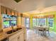 Well-lit kitchen featuring granite counters, dining nook, and backyard views at 3509 Oak Lake Dr, Palm Harbor, FL 34684