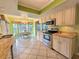 Bright kitchen with stainless steel appliances, granite countertops, and a casual dining nook at 3509 Oak Lake Dr, Palm Harbor, FL 34684