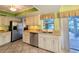 Bright kitchen features stainless steel appliances, granite countertops, and tiled floor at 3509 Oak Lake Dr, Palm Harbor, FL 34684