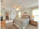 Spacious main bedroom with ceiling fan, neutral carpeting, and ensuite bathroom access at 3509 Oak Lake Dr, Palm Harbor, FL 34684