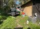 Exterior view of a backyard with overgrown vegetation and an RV at 3512 16Th E St, Bradenton, FL 34208