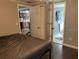Bedroom showcasing hardwood floors, gray walls, and view to ensuite bathroom and kitchen at 3512 16Th E St, Bradenton, FL 34208