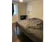 Simple bedroom with hardwood floors, natural light, and neutral walls at 3512 16Th E St, Bradenton, FL 34208