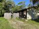 Exterior of home with boarded windows and weathered siding at 3512 16Th E St, Bradenton, FL 34208