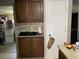 Kitchen features tiled backsplash and dark wood cabinets at 3512 16Th E St, Bradenton, FL 34208