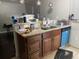 Kitchen with sink, cabinets, granite countertops and blue dishwasher at 3512 16Th E St, Bradenton, FL 34208