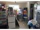 Room with neutral walls containing bins, boxes, and a stainless steel refrigerator at 3512 16Th E St, Bradenton, FL 34208