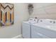 Bright laundry room featuring a washer and dryer hookups with shelving at 35496 Valley Ridge Rd, Dade City, FL 33525