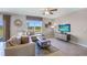 Cozy living room with neutral tones, comfortable sectional sofa, and large window with a serene pond view at 35496 Valley Ridge Rd, Dade City, FL 33525