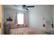 Light and airy bedroom features a bed, desk, and vanity at 36439 Garden Wall Way, Zephyrhills, FL 33541