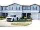 Townhomes feature a neutral palette, shuttered windows and attached garages at 36439 Garden Wall Way, Zephyrhills, FL 33541