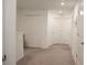 Upstairs hallway with carpet, doors, and a view of the stairway at 36439 Garden Wall Way, Zephyrhills, FL 33541