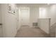 Bright hallway features neutral carpet and multiple doors for easy access to rooms at 36439 Garden Wall Way, Zephyrhills, FL 33541